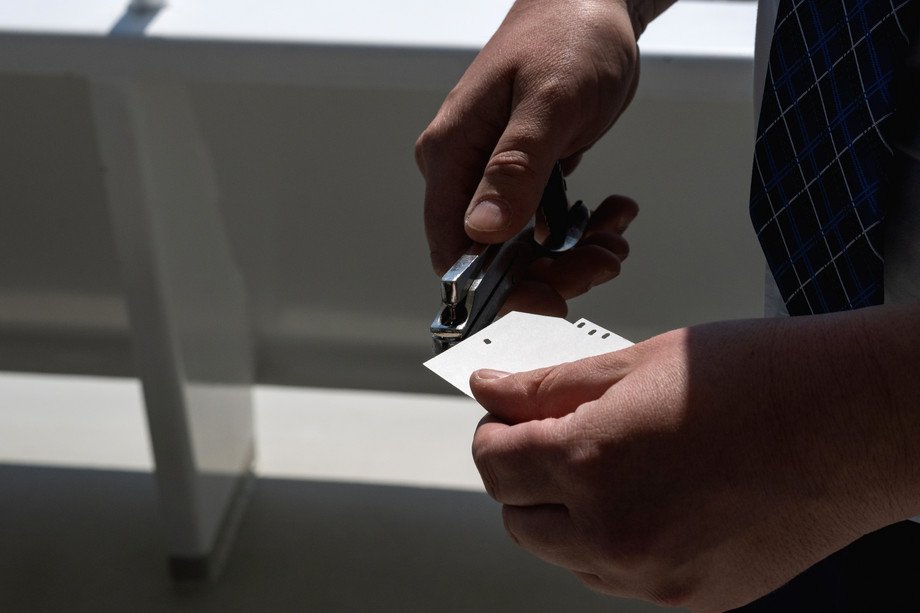 Ticket control Lake Zug Hands holding the ticket and puncher